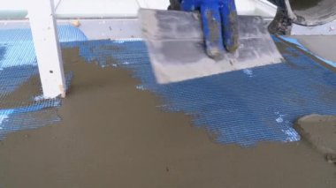 Endüstriyel dağcı, fiberglas örgü üzerinde Trowel macunu yapıştırıcısı kullanarak dış cepheyi izole ediyor.