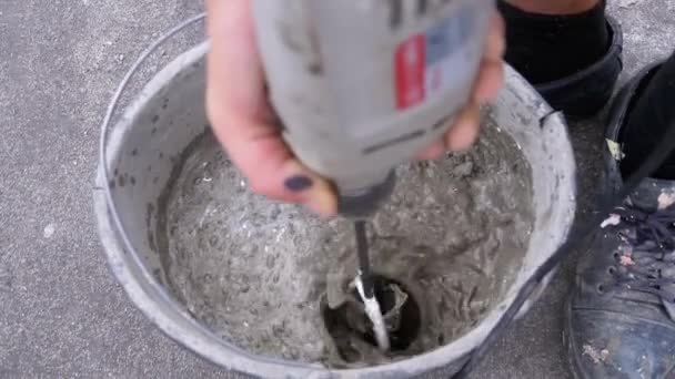 Mixing Building Cement with Water in Bucket Use Construction Mixer. Slow Motion — Stock Video