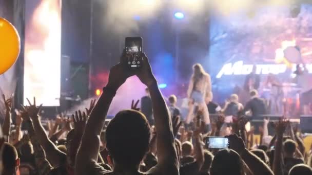 Male Hand with Smartphone Making Video at Live Rock Concert. Slow Motion — Stock Video