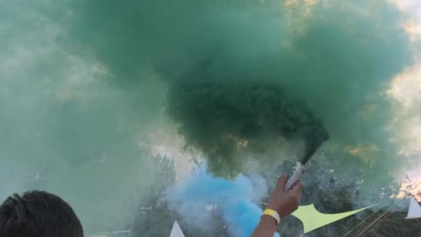 Людина, маючи розвагу з кольоровим димом спалахує проти неба. Повільний рух — стокове відео