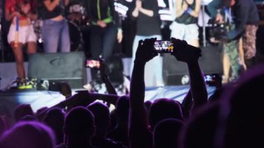 Silhouette of Man Hands Live Rock konserinde Smartphone ile video çekiyor. Yavaş Hareket