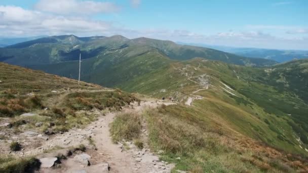 Groupe de touristes avec sacs à dos de randonnée descend la chaîne de montagnes. Vue arrière — Video