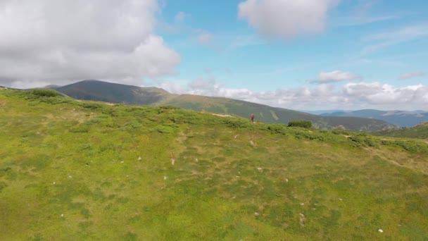 Flygfoto av en resenär med ryggsäck Klättring längs bergssluttningen. Episkt skott — Stockvideo