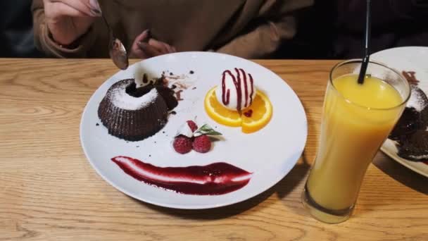 Dziewczyny jedzące słodki deser w restauracji. Czekoladowy Fondant. — Wideo stockowe