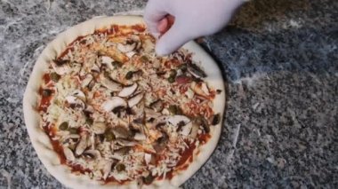 Şef El lezzetli bir şekilde dilimlenmiş sosisi pizzaya fırlatıyor. Yavaş Hareket