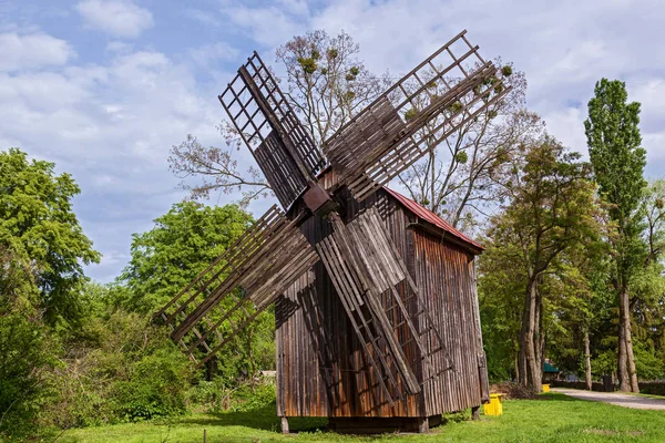 An old wooden mill. Old windmill in the museum of architecture