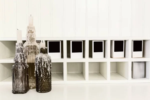Botellas Con Una Vela Sobre Una Mesa Blanca —  Fotos de Stock