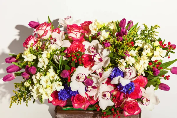 A beautiful arrangement of fresh flowers tulips, archdeus, chrysanthemums and roses on a white background. Flowers for the holiday of March 8, birthday, February 14