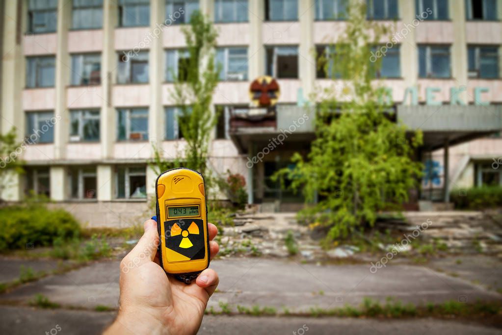 A dosimeter in hands with a level of radioactivity in the city of Pripyat, a ghost town of the Chernobyl nuclear power plant affected by a nuclear disaster in 1986, Chernobyl Exclusion Zone, Ukraine.