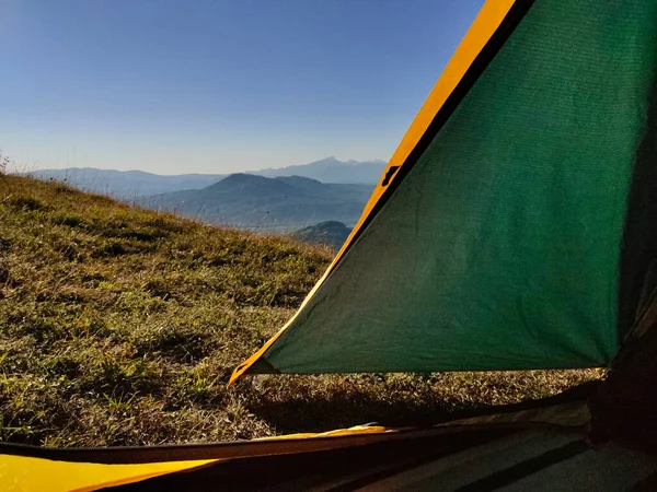 View from the tent to the landscape of beautiful green mountains in the early morning in Adygea