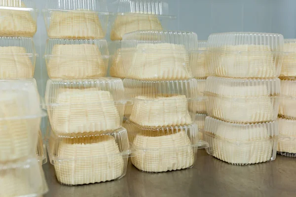 Cheese packed in food-grade transparent containers, for store sale