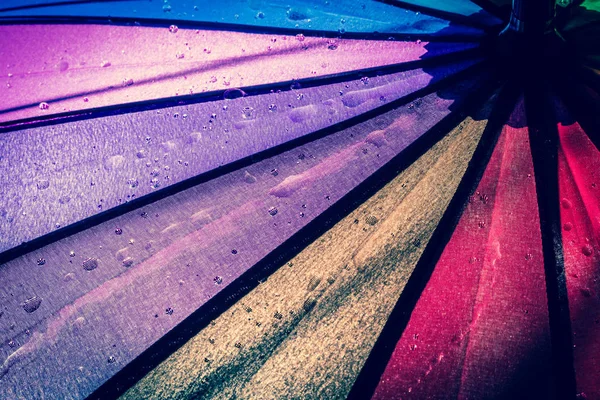 Çok renkli renkli şemsiye yağmur damlaları ile gökkuşağının bütün renkleri ile. Vintage, grunge, eski, retro tarzı fotoğraf.