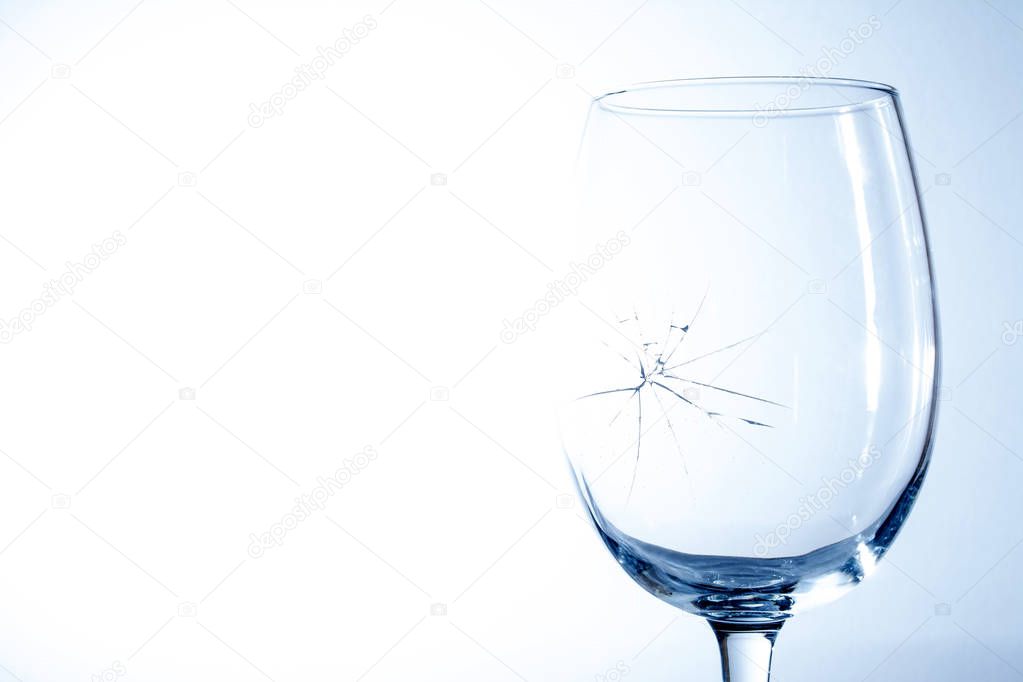 Broken wine glass on a blue background