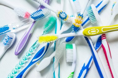 Farklı renkteki diş fırçası bir beyaz vintage zemin üzerine kapatın. Yukarıdan görüntülemek.