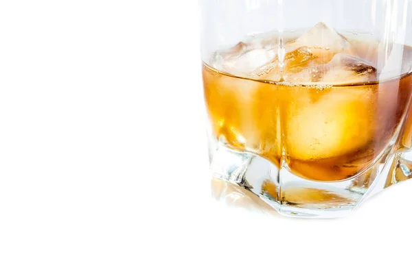 Whiskey with ice close-up in a glass isolated on a white background — Stock Photo, Image