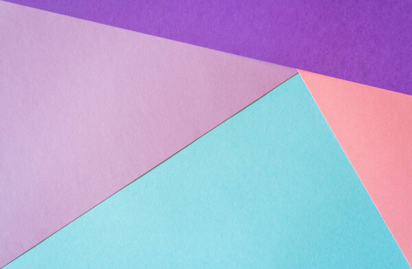 Multicolored paper background in soft blue, violet, lilac and coral colors.