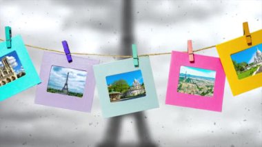 Paris 'in yaz aylarındaki ana manzarasının yaratıcı yavaş çekim videosu. Üzerinde mandallar olan bir iple kışın Eyfel Kulesi ile Paris' in panoramasının önünde..