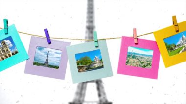 Paris 'in yaz aylarındaki ana manzarasının yaratıcı yavaş çekim videosu. Üzerinde mandallar olan bir iple kışın Eyfel Kulesi ile Paris' in panoramasının önünde..