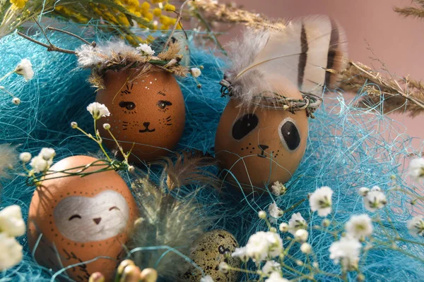 Easter holiday concept with cute handmade eggs, rabbit, chicks, owl, panda and deer. Creative eggs for Easter. Happy easter