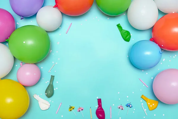 Pastel balloons and white confetti on blue background