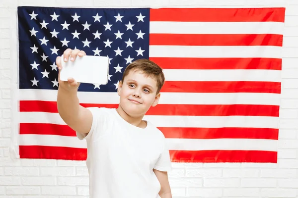 boy making selfie on american flag background
