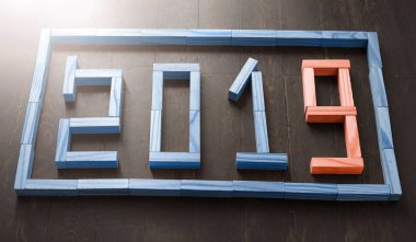 İş ve tasarım konsepti - gerçeküstü geometrik yüzen tahta küp ile ahşap zemin üzerinde kelime 2019 kavramı soyut; Kopyalama alanı boş, ahşap 2019 rakamları masaya yalan.