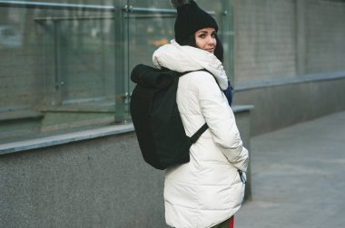 Geri şehirde yürüyüş yaparken seyir sırt çantası ile şık kız