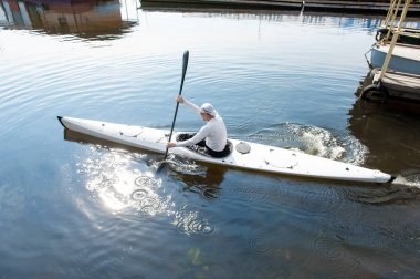 Güneşli yaz havasında sığ sularda kano yakan adam