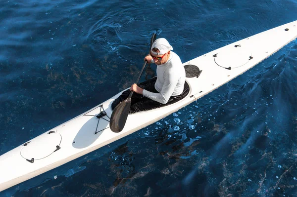 Mannelijke paddler zittend in witte moderne kajak — Stockfoto