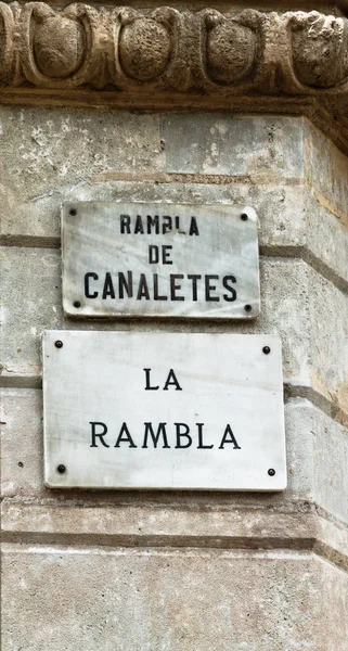 Famous tourist landmark - Street La Rambla in Barcelona, Catalonia, Spain. Plaque Sign Street with the name La Rambla and Ramala de Canaletes on the wall of a ancient building.