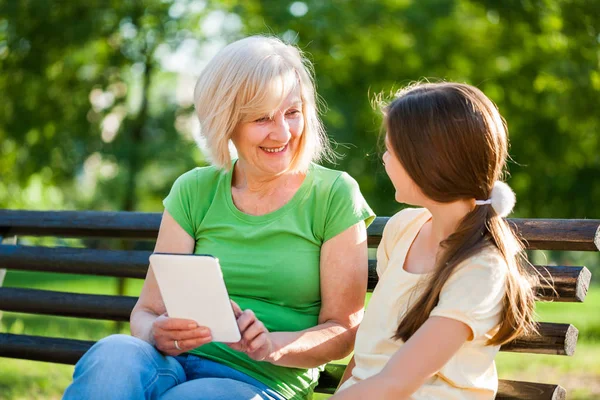 Grandmother Granddaughter Sitting Park Using Digital Tablet — Stock Photo, Image