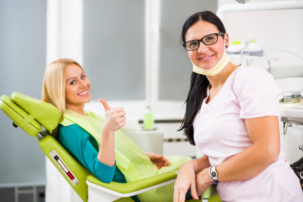 Happy young woman at dentist. 
