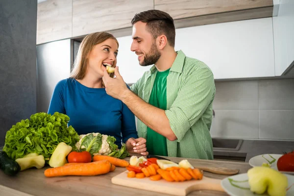 若いカップルは台所で食事を準備しています — ストック写真