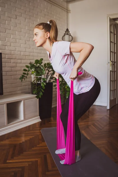 Mujer Joven Ejercitando Pilates Con Banda Elástica Casa — Foto de Stock