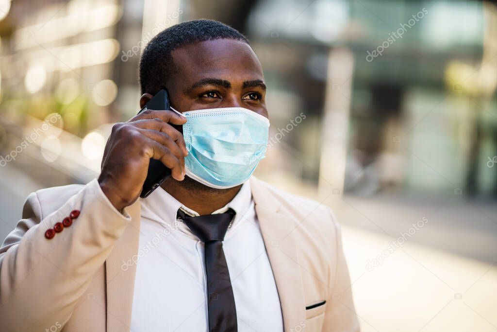 Portrait of responsible businessman who is wearing protective mask. Covid-19 virus pandemic concept.