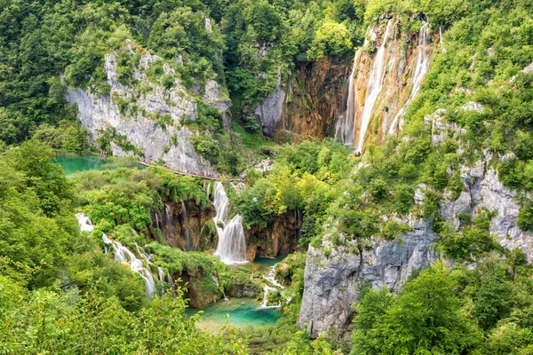 Panoramic view of waterfalls, rocks and lakes from popular tourist viewpoint in Plitvice Lakes National park. Amazing nature summer landscape, famous landmark in Croatia