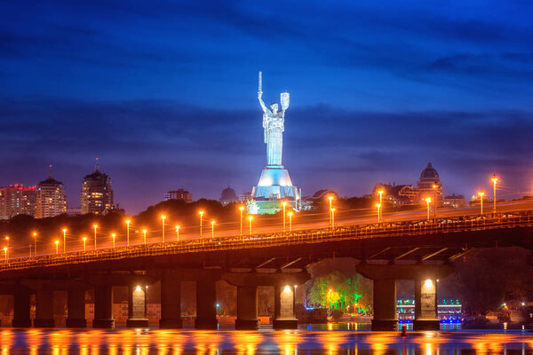 Kiev, Ukraine - May 04, 2018: View of the Paton bridge, Motherland monument and Dnieper river at night, beautiful cityscape with city lights, Kyiv the capital of Ukraine