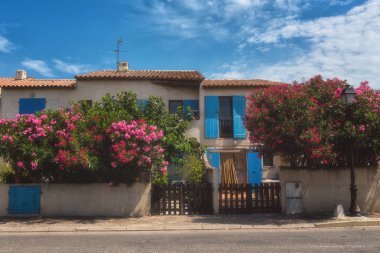 Saintes-Maries-de-la-Mer, küçük Akdeniz kasabası, çiçek açması zakkum çiçekleri ile süslenmiş mavi panjurlar ile beyaz ev sahipliği yapmaktadır. Popüler turizm Camargue, Provence, Fransa
