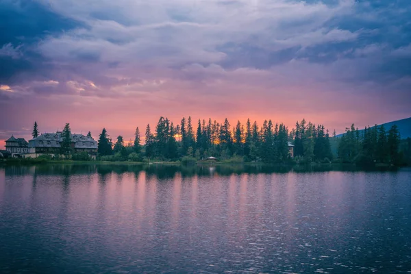 Amazing nature landscape for wallpaper, cloudy colorful sunset over the alpine lake Strbske pleso, High Tatras, Slovakia (Slovensko)