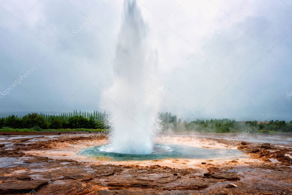 Magnificent Strokkur Geyser erupts the fountain of azure water, popular tourist attraction, Haukadalur geothermal area, Iceland