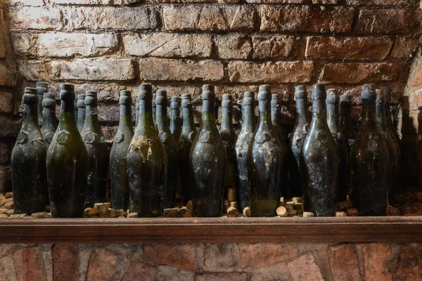 Old wine bottles on the shelf, wine cellar