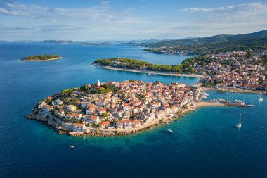 Aerial view of Primosten old town on the islet, amazing sunny landscape, Dalmatia, Croatia. Famous tourist resort on Adriatic sea coast, outdoor travel background clipart