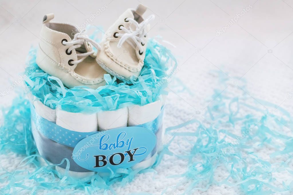 Present cake with diapers for newborn baby boy