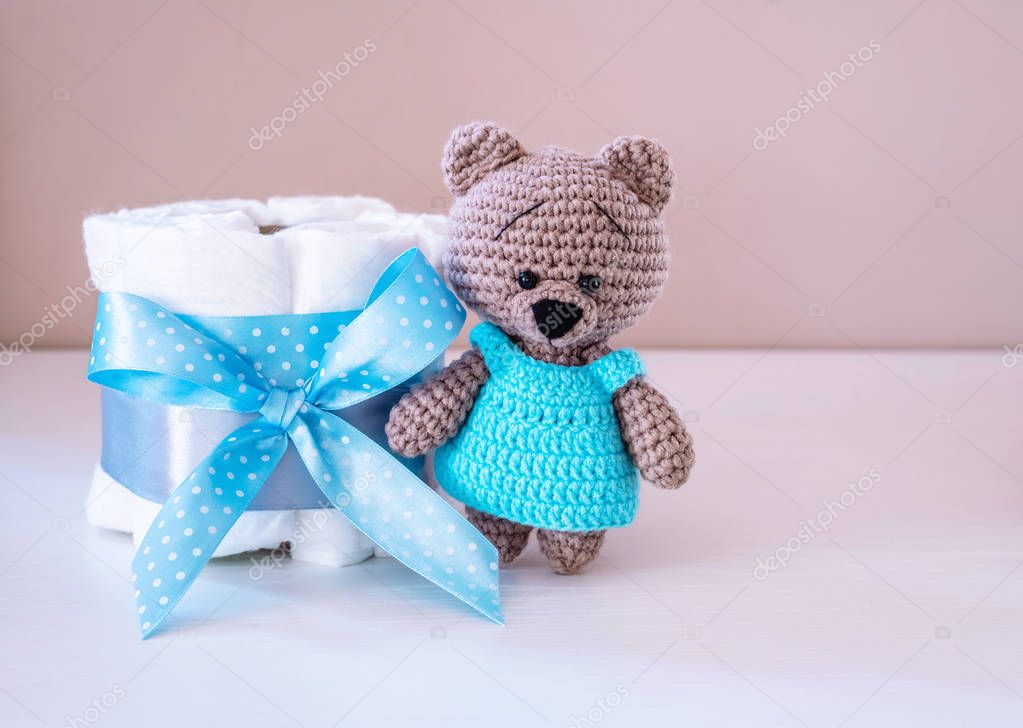 Present cake with diapers for newborn baby boy with little teddy