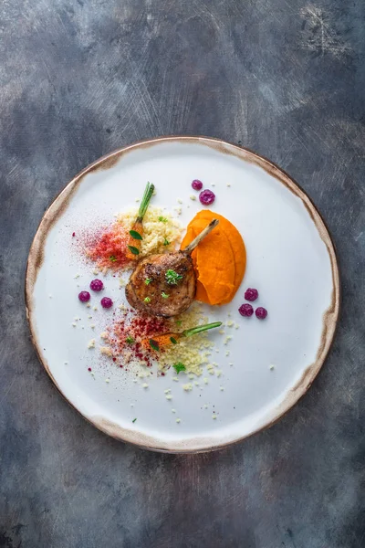 Duck leg confit with batat puree, carrots and couscous, restaurant meal, copy space — Stock Photo, Image