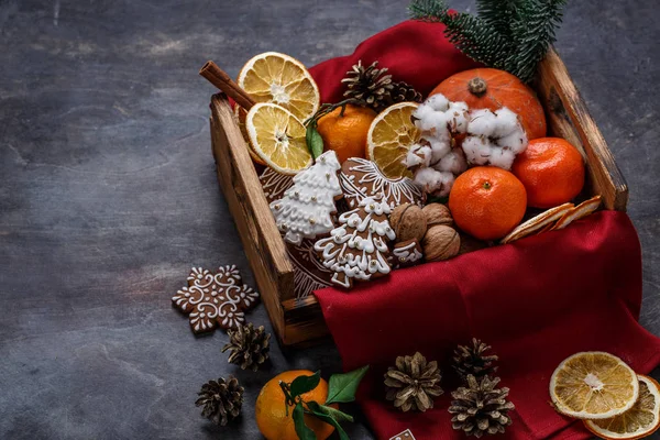 Gingerbread cookies, dry oranges, tangerines and nuts for christmas decoration, copyspace