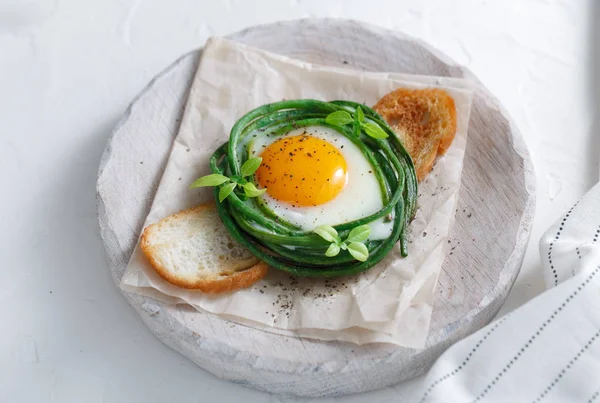 Green beans with sunny side fried egg on toast