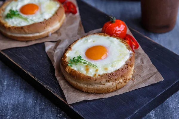 Buns with melted cheese and yolks, dark photo