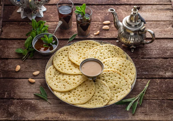 Baghrir with honey, almond sauce and mint tea