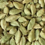 Top view on a pile of dry scattered unrefined cardamom seeds